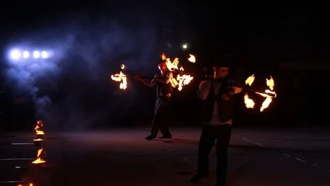 Two guys dance with burning wands Stock Footage 84547818