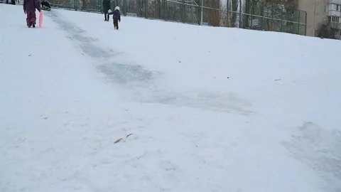 Two guys descend on a sled from a hill. Slow motion 01.10.2020 Ukraine, Kiev Stock-Footage 126635722