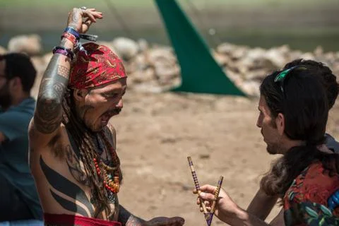 Two guys during a rape ceremony at the Lost Theory psytrance music festival Stock Photos