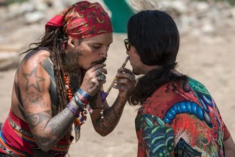 Two guys during a rape ceremony at the Lost Theory psytrance music festival Stock Photos
