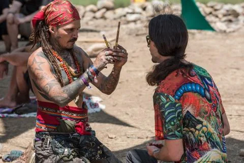 Two guys during a rape ceremony at the Lost Theory psytrance music festival Stock Photos