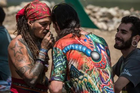 Two guys during a rape ceremony at the Lost Theory psytrance music festival Stock Photos