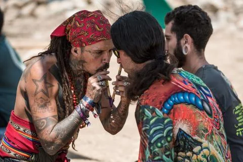 Two guys during a rape ceremony at the Lost Theory psytrance music festival Stock Photos