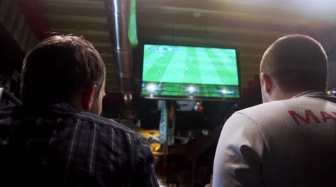 Two guys ia playing videogames in the pub Stock Footage 56479936