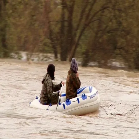 Two guys in an inflatable boat on the river after rains Stock Footage 69295728