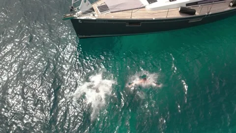 Two guys jumping from a yacht Stock Footage 193994418