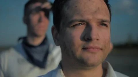 Two guys looking into the distance at the sunset Stock Footage 137845431