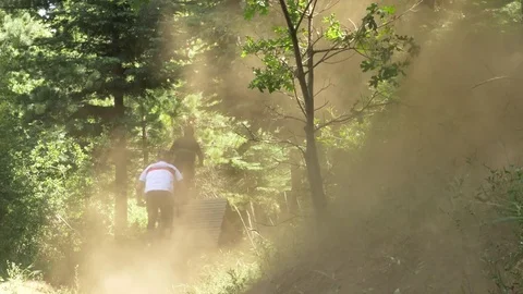 Two guys mountain biking and making a dust cloud . 動画素材 77576063