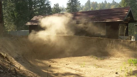 Two guys mountain biking a steep corner and making a dust cloud. Video stock 77586676