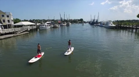 Two Guys Paddle Boarding Stock Footage 56873357
