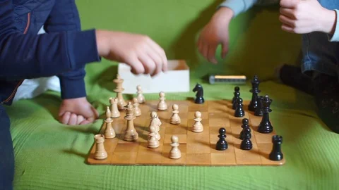 Two guys play chess while sitting at school Видео 118435477