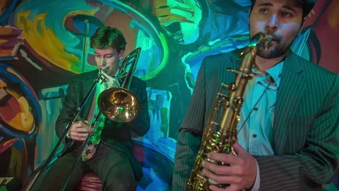 Two guys playing different musical instruments Stock Footage 112190151