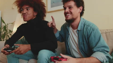 Two guys playing on games console together Stock Footage 261466366