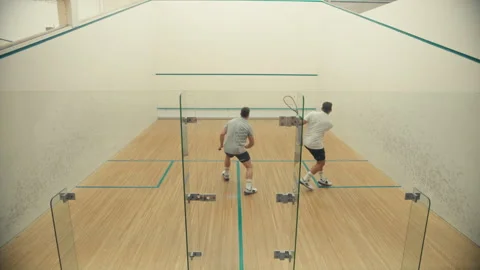 Two guys playing squash at the court Stock Footage 278973609