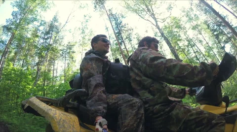 Two guys on quad ride through the forest Stock Footage 57707276