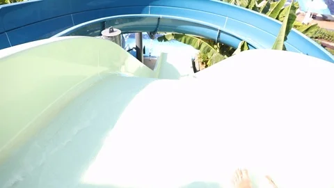 Two guys sliding down fun water slide and have fun Stock Footage 101286461