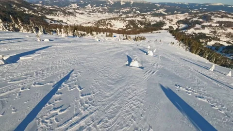 Two guys on snowmobile jumps and rides in the winter at sunlight. Aerial top Stock Footage 189403620