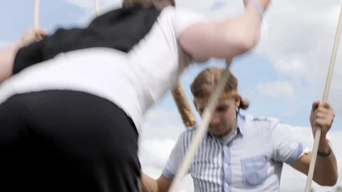 Two guys swinging on a swing Video stock 103918229