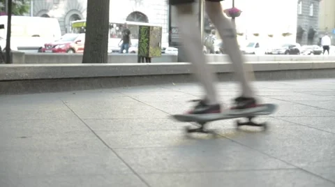 Two guys take turns to perform tricks on a skateboard in a roadside park Stock Footage 51754643