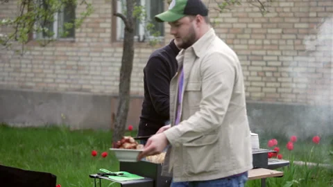 Two guys through a picnic Stock-Footage 277105558