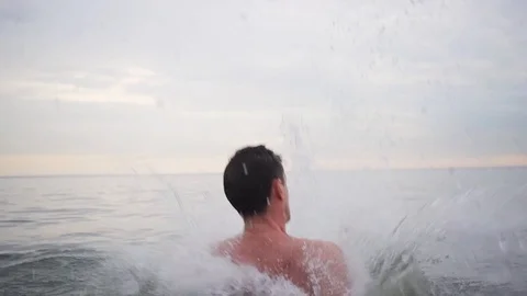 Two guys throw a third over the water and he makes a flip back and dives 스톡 동영상 90811698