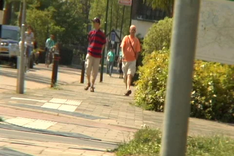 Two guys walking down dutch road Stock Footage 265599