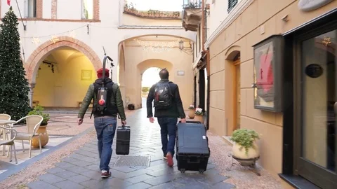 Two guys walking with electronic equipment Stock Footage 85444181