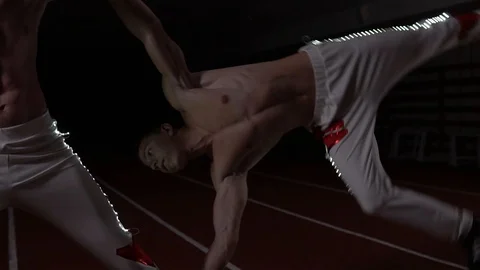 Two gymnasts and acrobats perform sports power stance Stock Footage 129472646