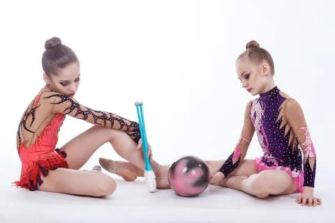 Two gymnasts sit on the floor Stock Photos