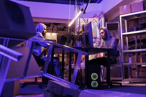 Two hackers coding computer worm Stock Photos