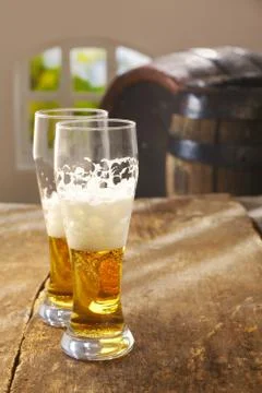 Two half drunk glasses of beer Stock Photos