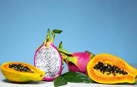 Two Half of Fresh organic Dragon Fruit on a blue background, creative summer Stock Photos