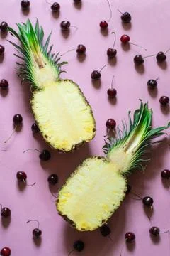 Two half of fresh pineapple on pink background with cherry Stock Photos