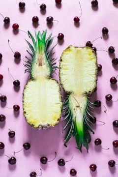 Two half of fresh pineapple on pink background with cherry Stock Photos