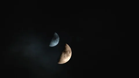 Two half moons with clouds passing Stock Footage 88962568