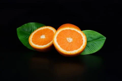 Two half ripe orange fruit Stock Photos