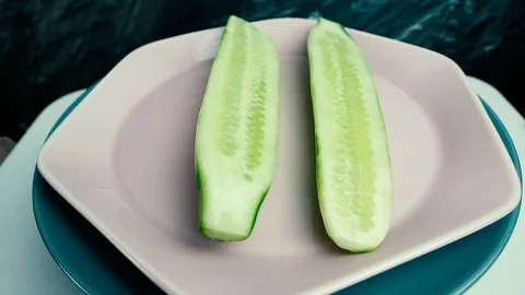 Two half sliced cucumbers rotate. Vegan healthy food concept Stock Footage 107734480