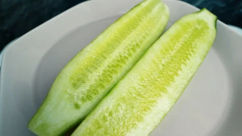 Two half sliced cucumbers rotate. Vegan healthy food concept Stock-Footage 107735123