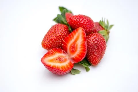 Two halfs of the ripe strawbery on the white background Stock Photos