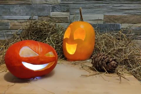 Two halloween jack o lanterns yellow and red with smoke on foreground on a ha Stock Photos