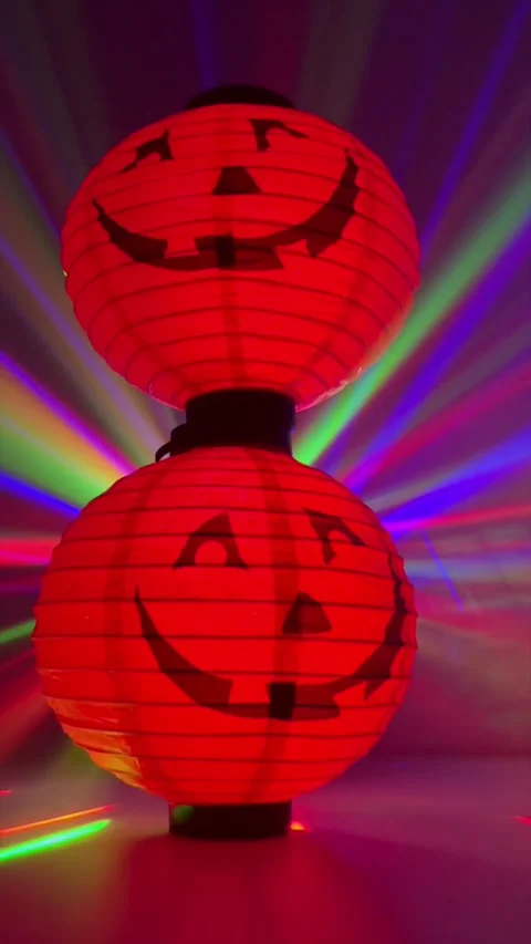 Two Halloween Lanterns with Colorful Disco Light Rays in Background Stock Footage 289786477