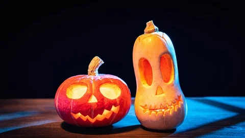 Two Halloween pumpkins in the moonlight on black background. Stock Footage 119220690