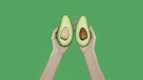 Two halves of avocado on green screen Stock Footage 71628740