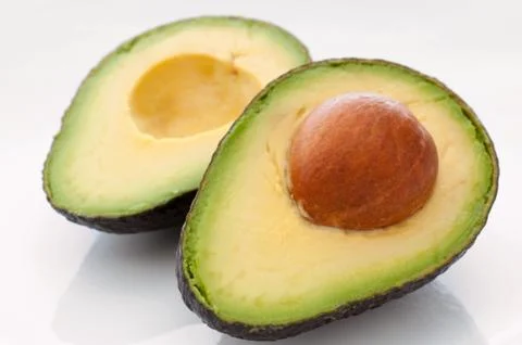 Two halves of an avocado pear Stock Photos
