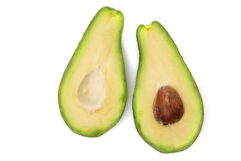 Two halves of avocado slices isolated on a white background Stock Photos