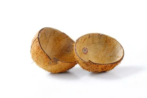 Two halves of a brown coconut shell Fotos de archivo