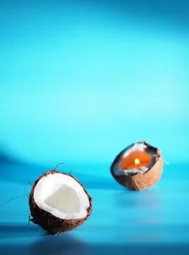 Two halves of coconut on a blue background Foto stock