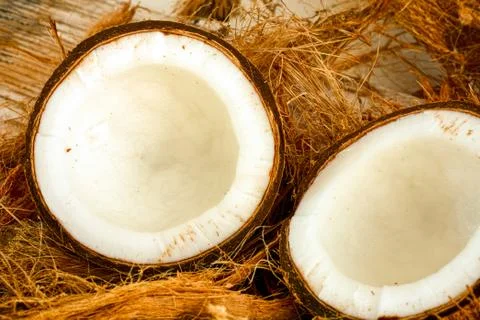 Two halves of coconut with coconut fiber Stock Photos