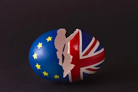 Two halves of cracked eggshell, one of which is decorated with the flag of Eu Stock Photos