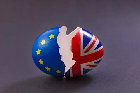 Two halves of cracked eggshell, one of which is decorated with the flag of Eu Stock Photos